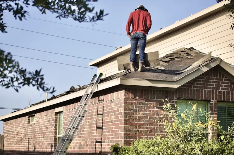 Professional roofer working on a residential roof in Preston City
